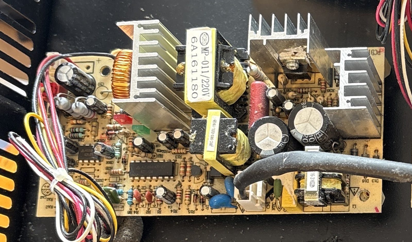 The left power supply board, full view: toroid, transformer, MP-011/220V label, bulk capacitors, heatsinks